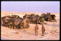 American soldiers standing around armed personnel carriers in the Gulf War, Saudi Arabia